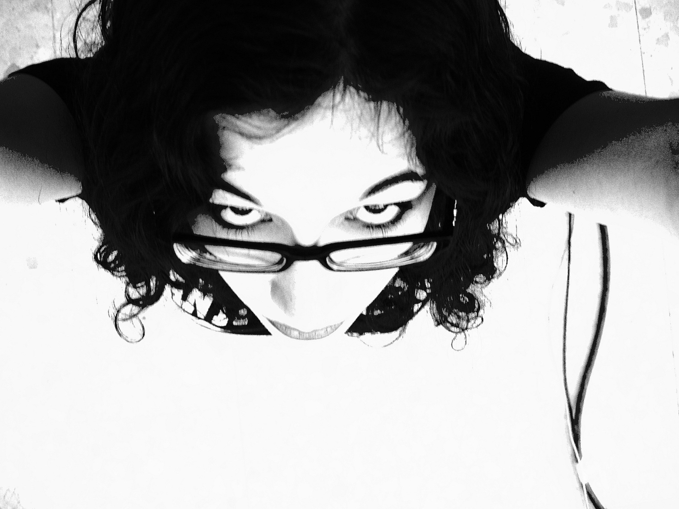 person with glasses looking up