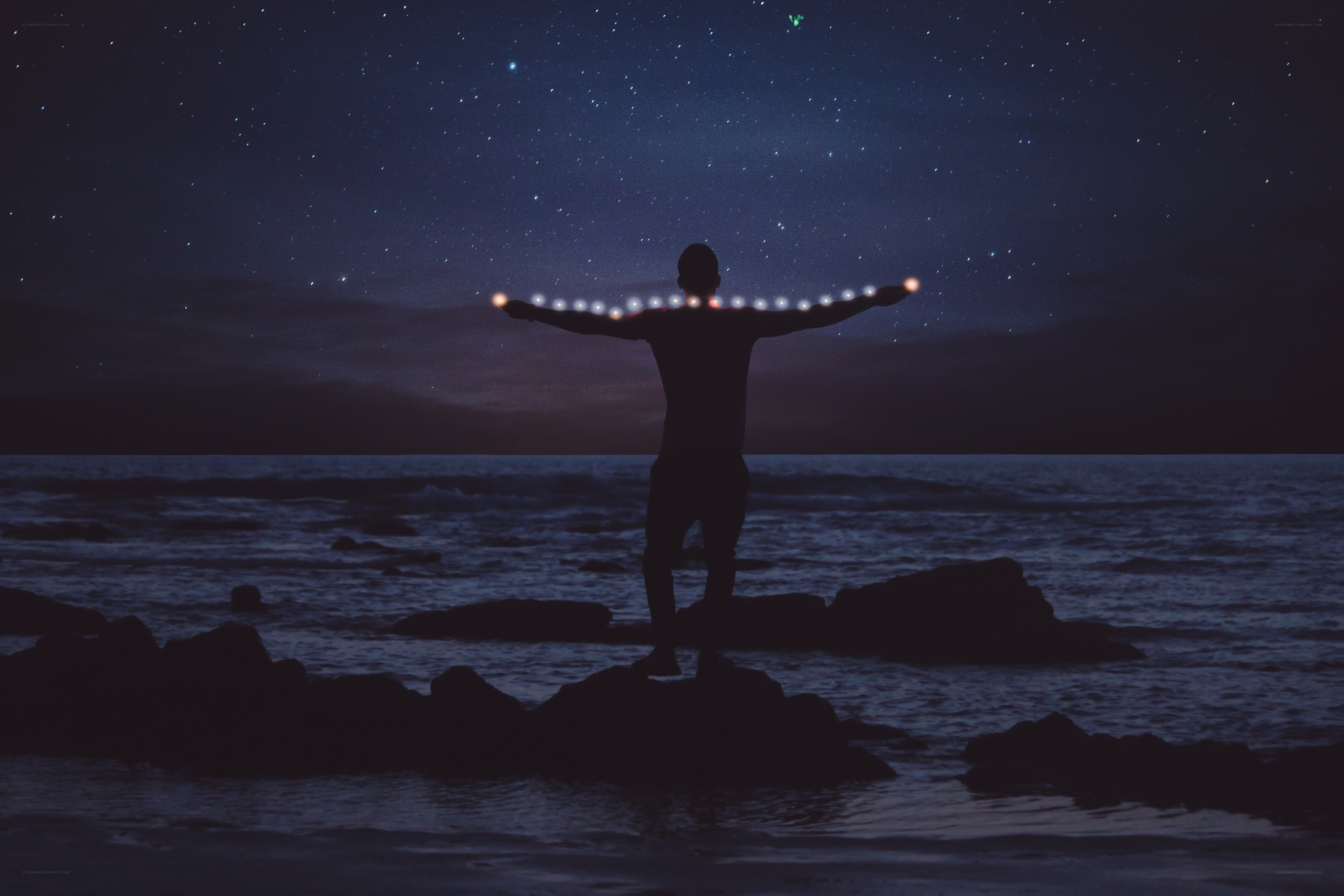 Person with glowing lights on arms