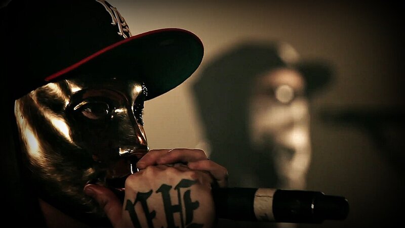 person with golden mask and microphone