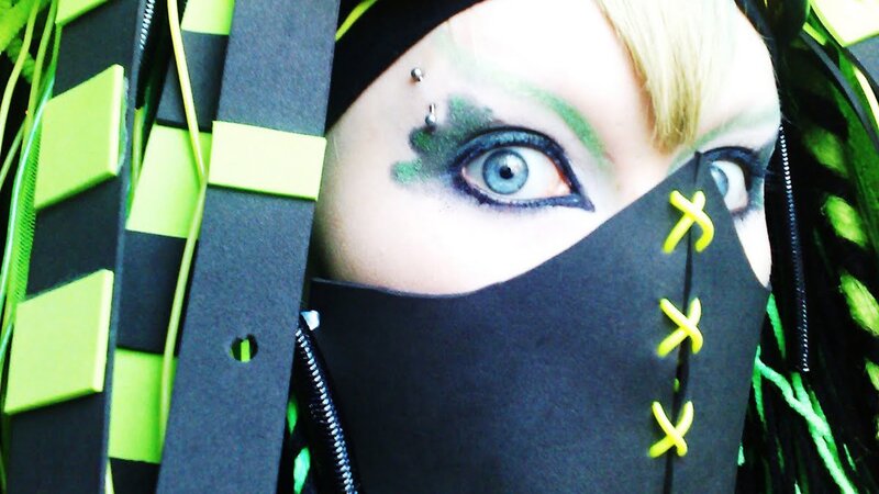 person with green and black costume