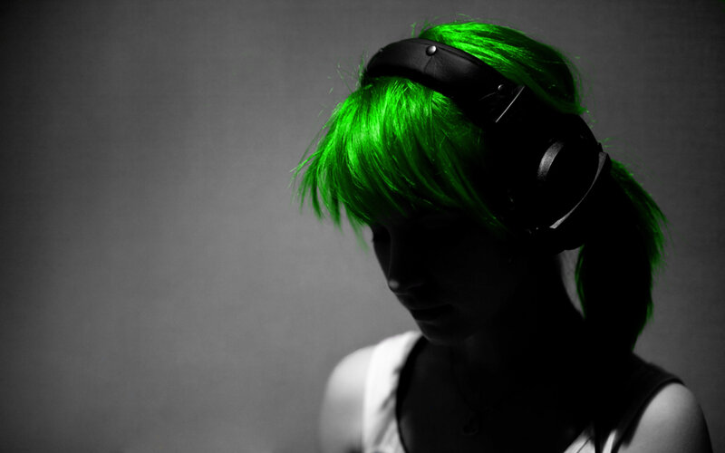 person with green hair and headphones