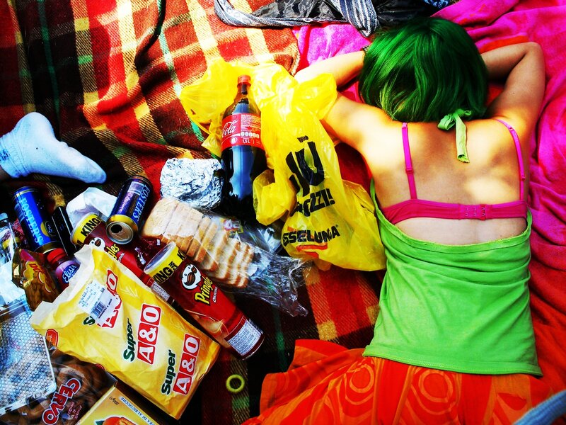 Person with green hair resting on blanket