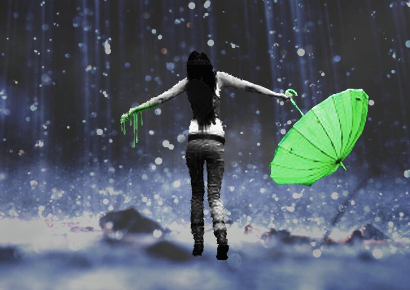 person with green umbrella in rain