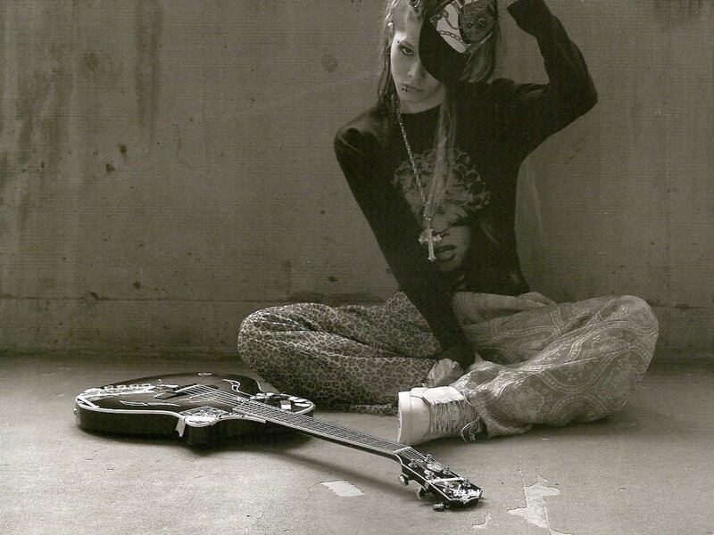 person with guitar on floor