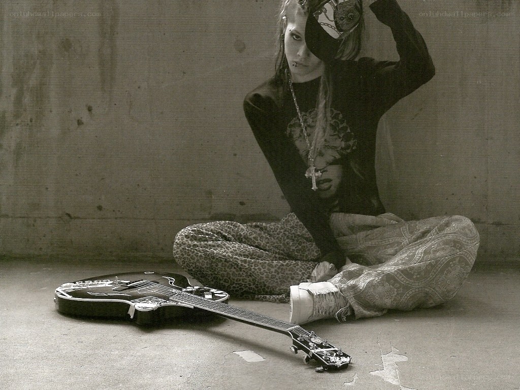 person with guitar on floor