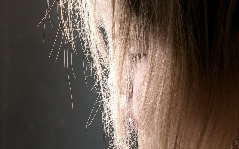 person with hair covering face