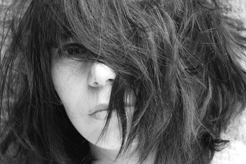 person with hair covering face