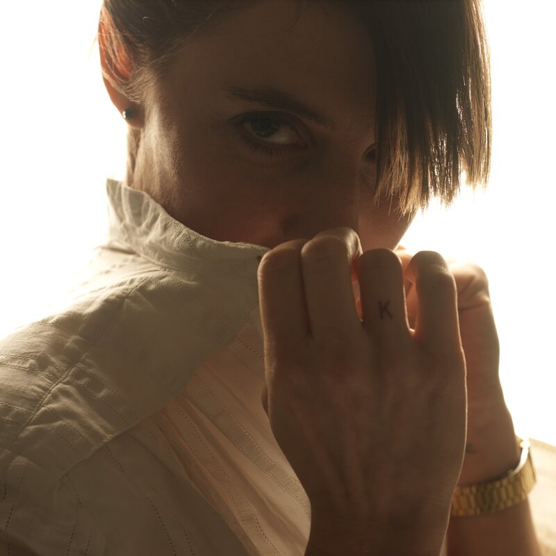 person with hand near face