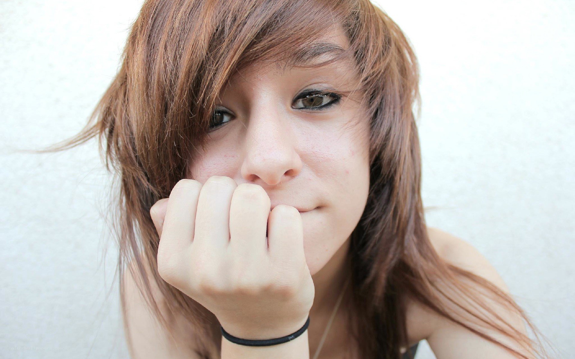 person with hand near face