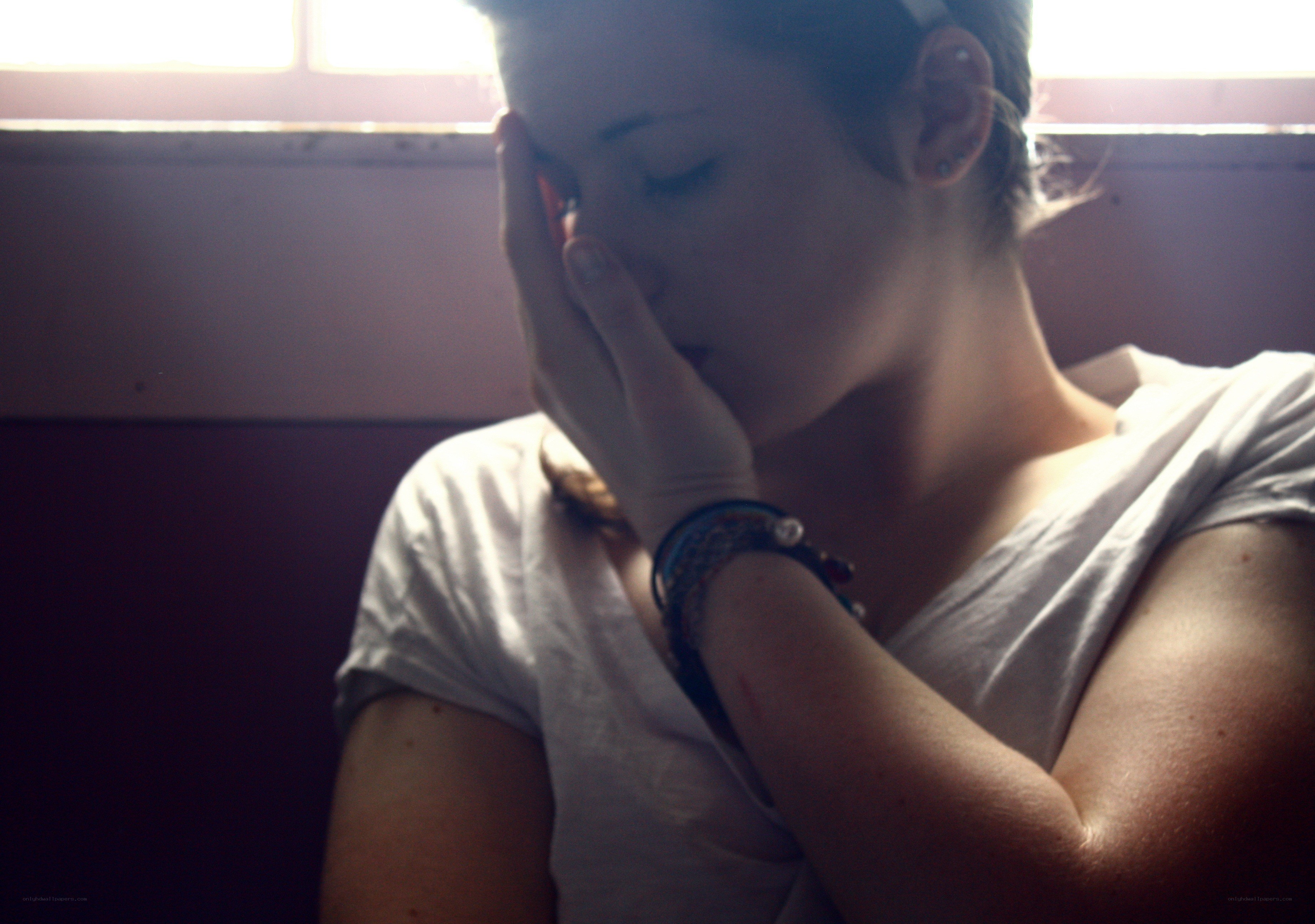person with hand on face