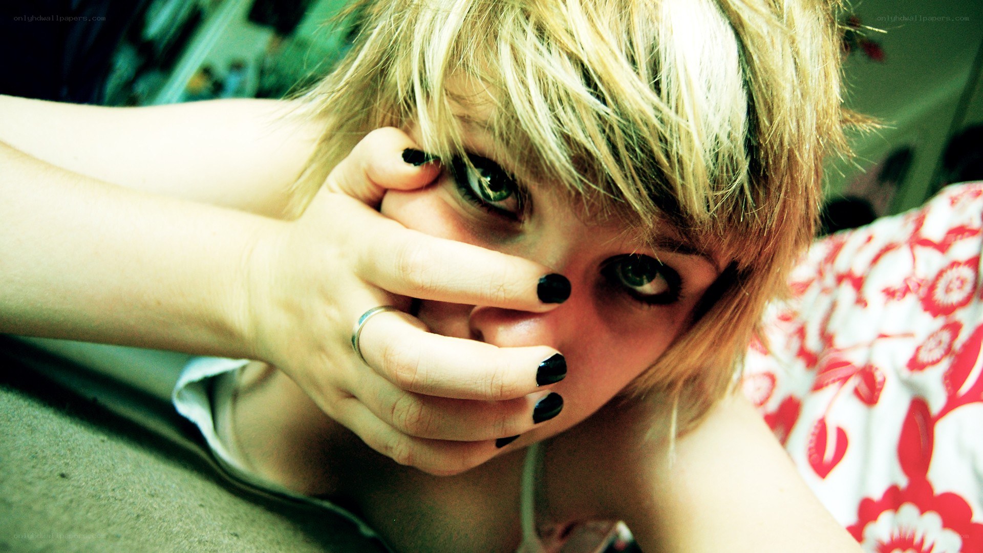 person with hand over mouth