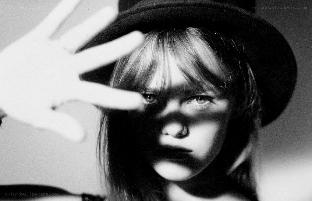person with hat and hand shadow