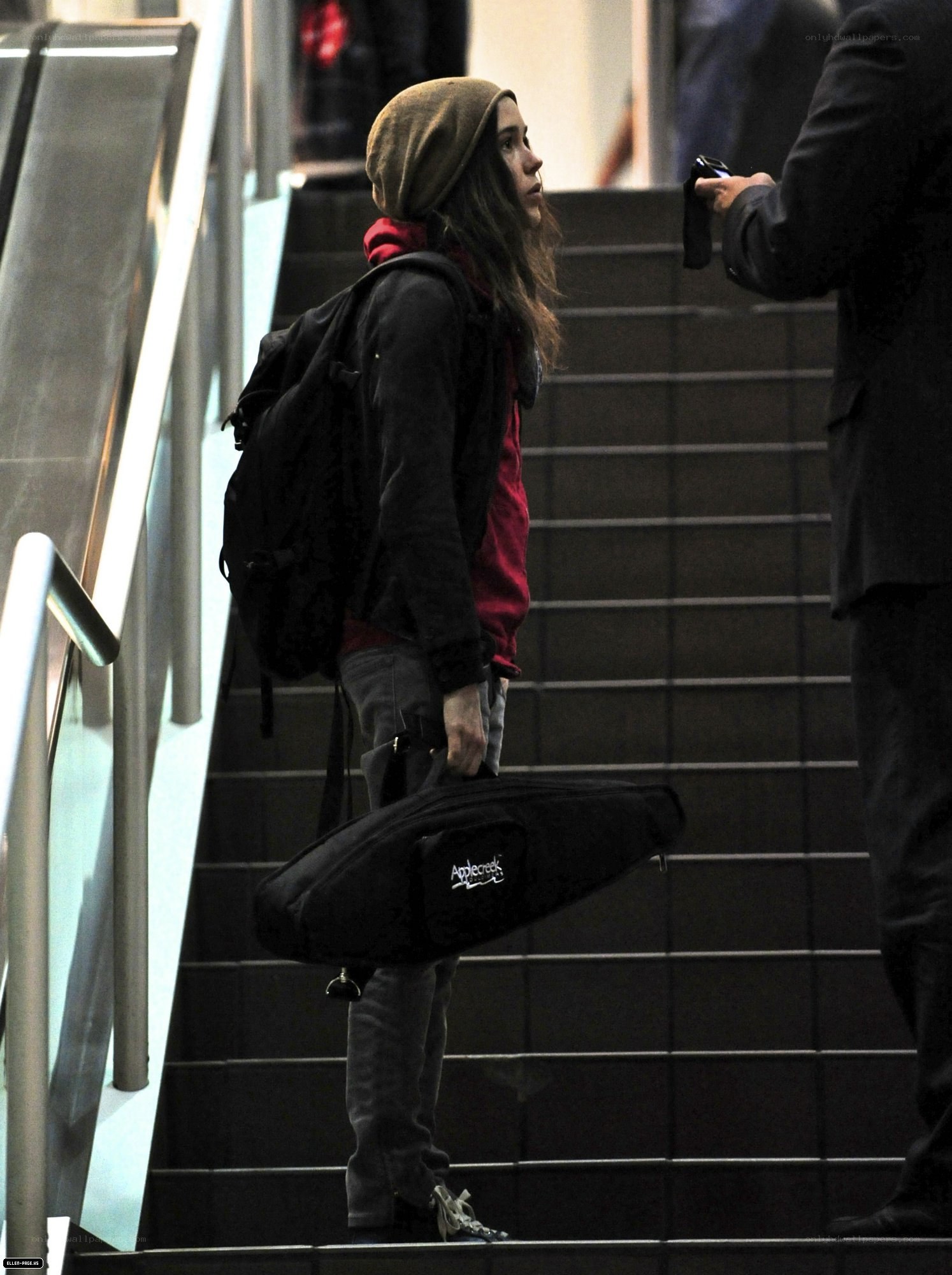 person with instrument case on stairs
