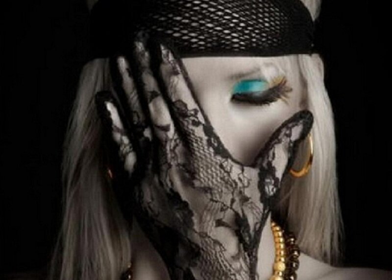 person with lace mask and blue eye makeup