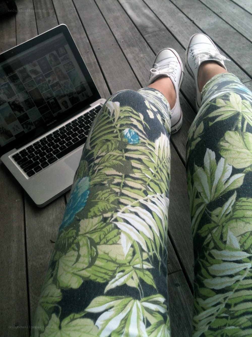 person with laptop on deck