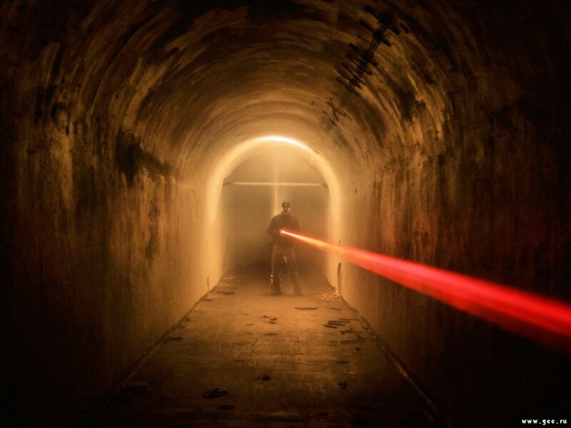Person with laser in tunnel