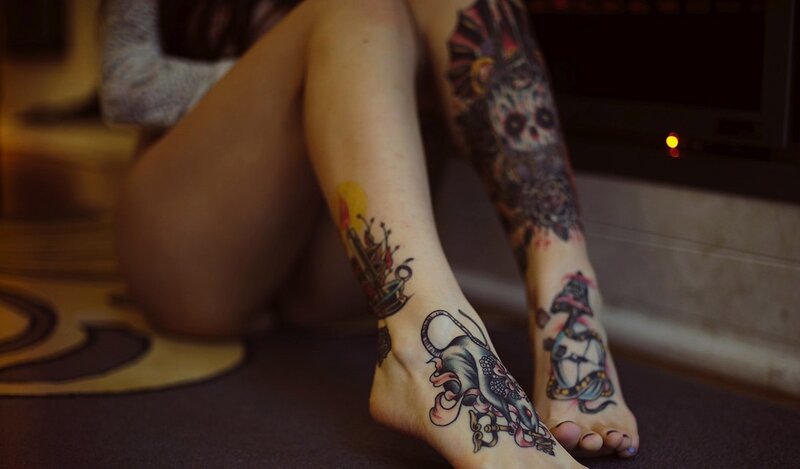 person with leg tattoos