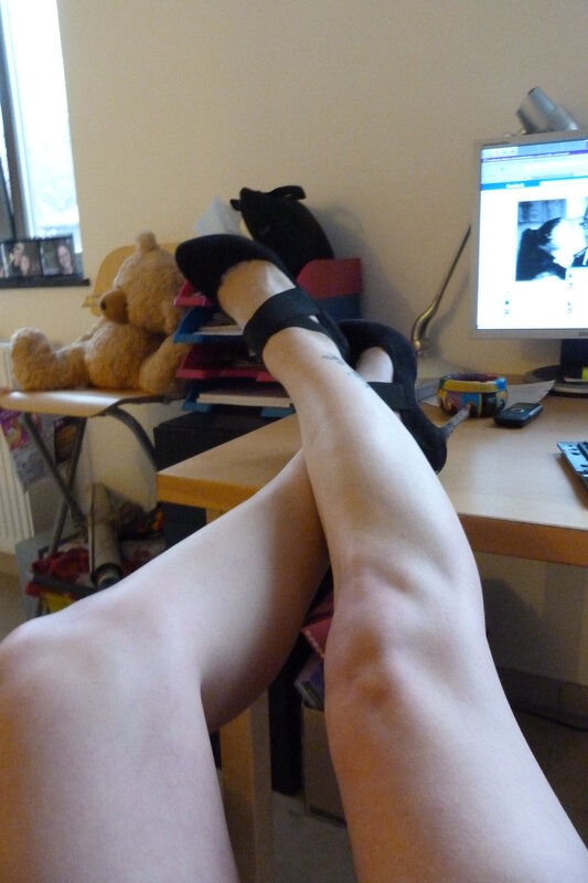 person with legs up on desk