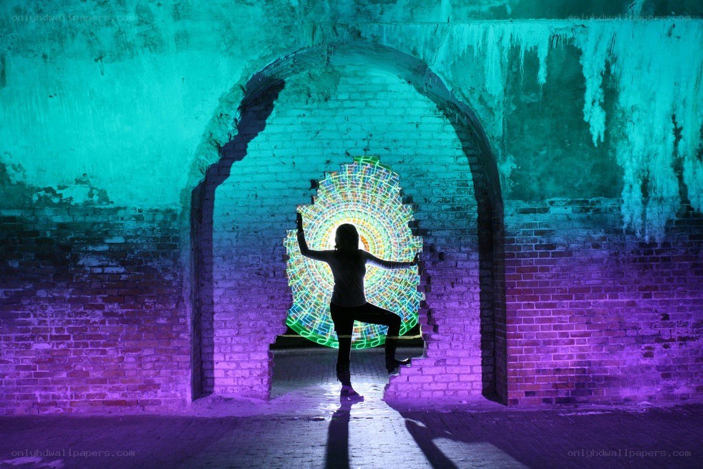person with light art in tunnel