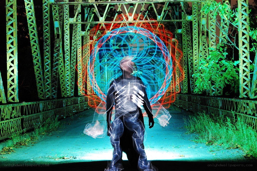 person with light trails on bridge