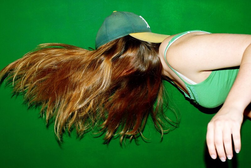 person with long hair and cap