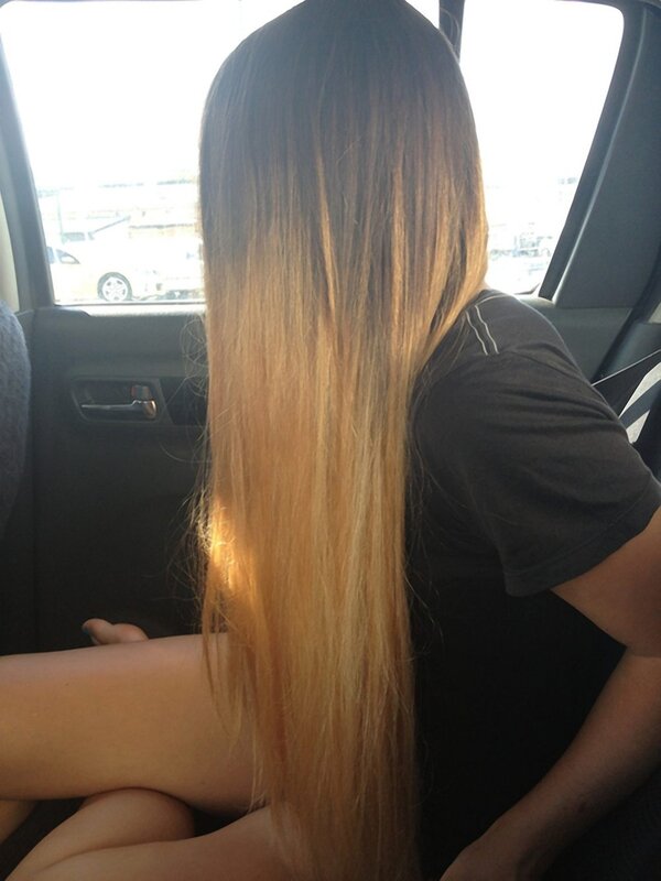 person with long hair in car