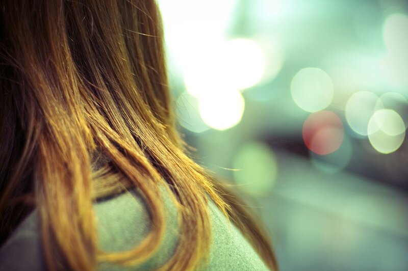 person with long hair in city