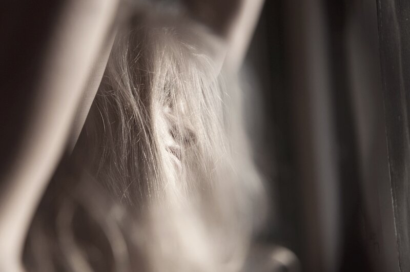 person with long hair in shadow