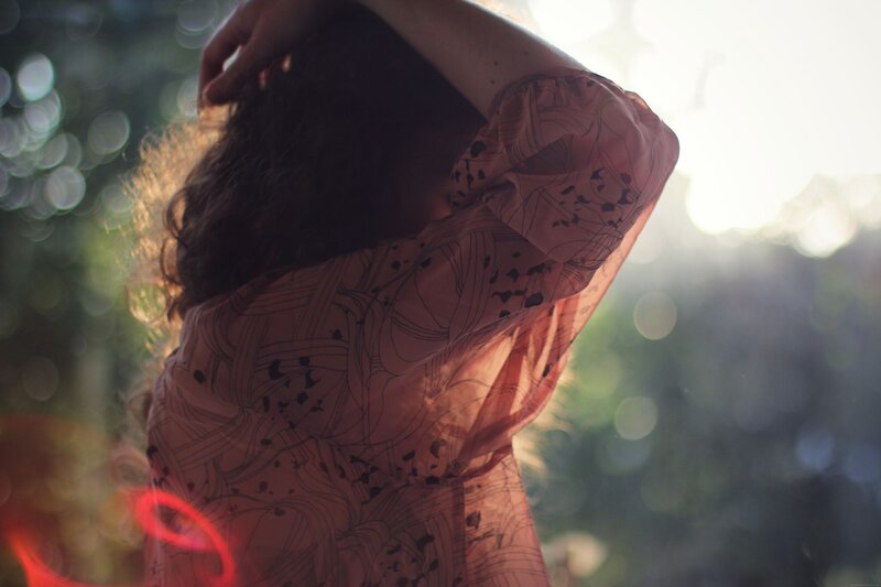person with long hair in sunlight