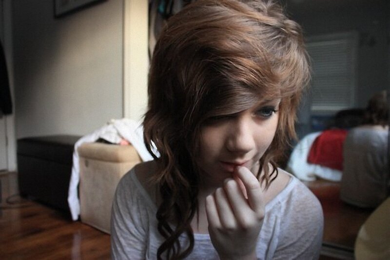 person with long hair looking down
