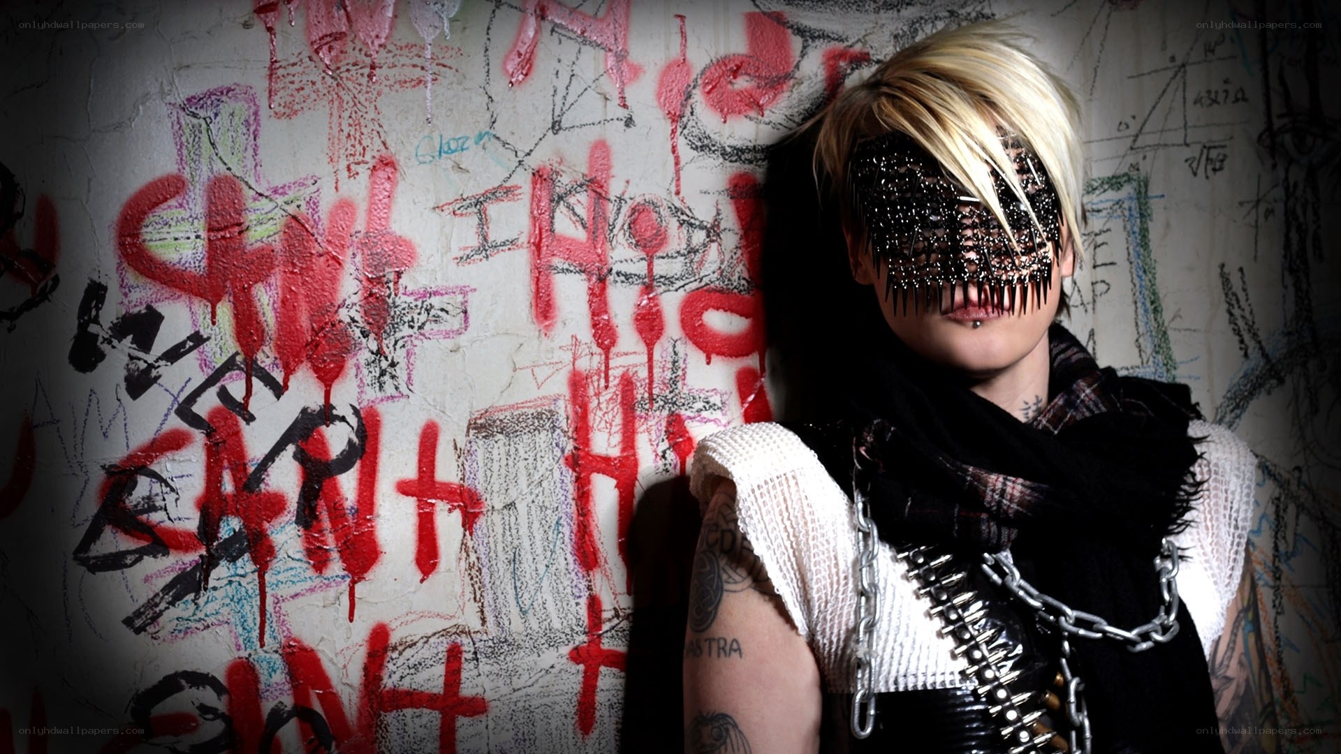 person with mask and graffiti wall