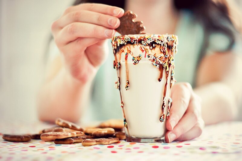 person with milkshake and cookies