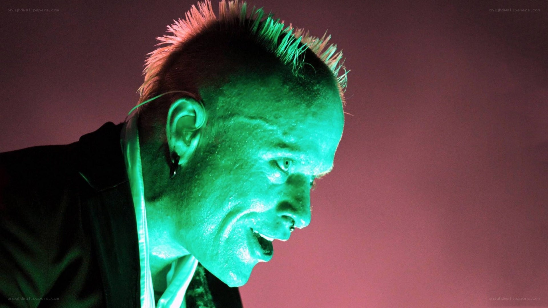person with mohawk under green light