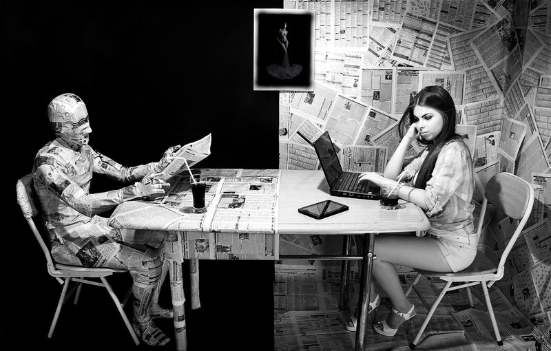 person with newspaper-covered figure