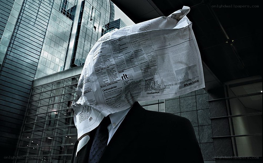 person with newspaper over head