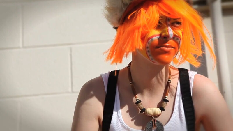 person with orange wig and face paint