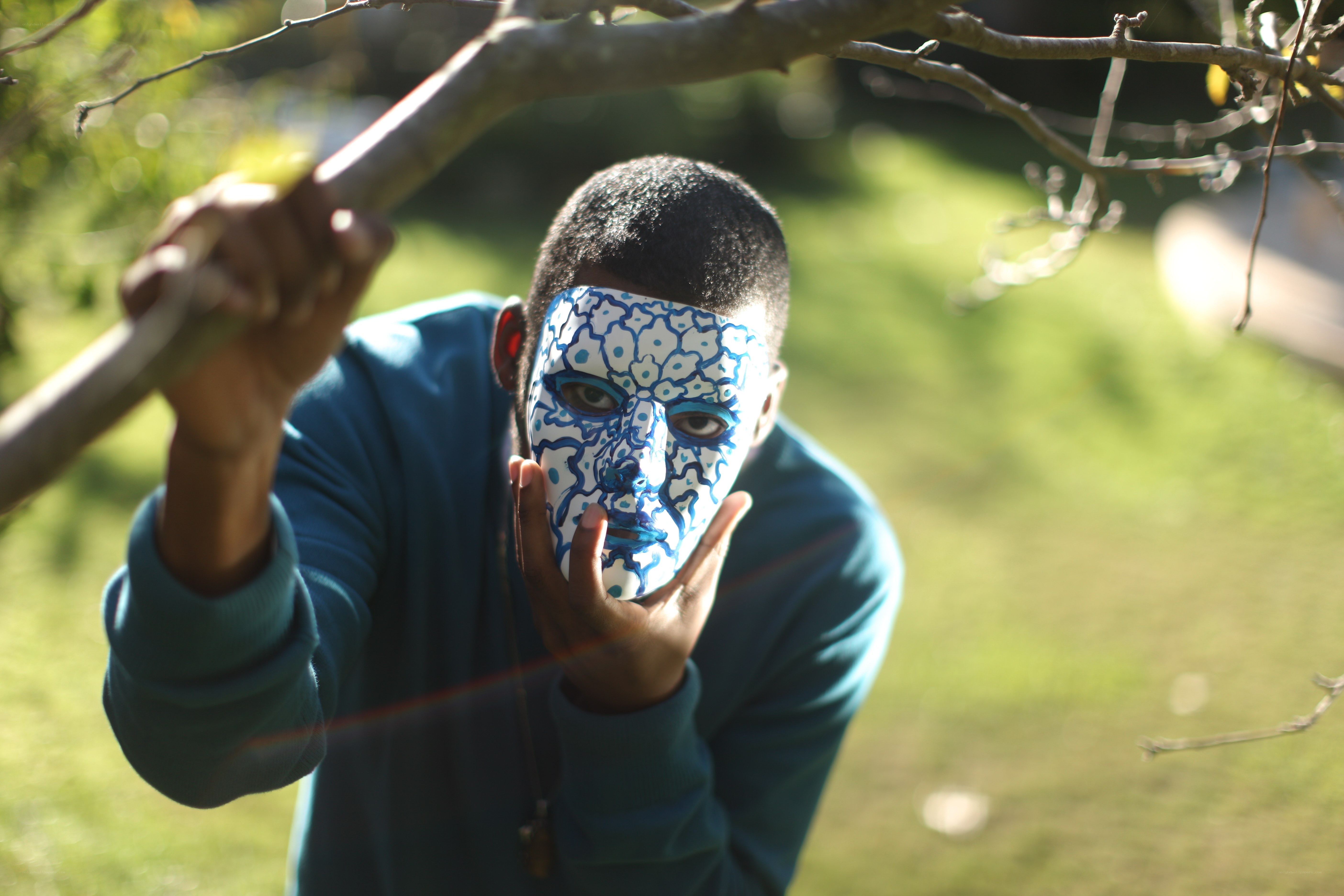 person with painted face in garden