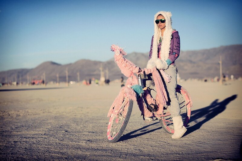 person with pink bike in desert