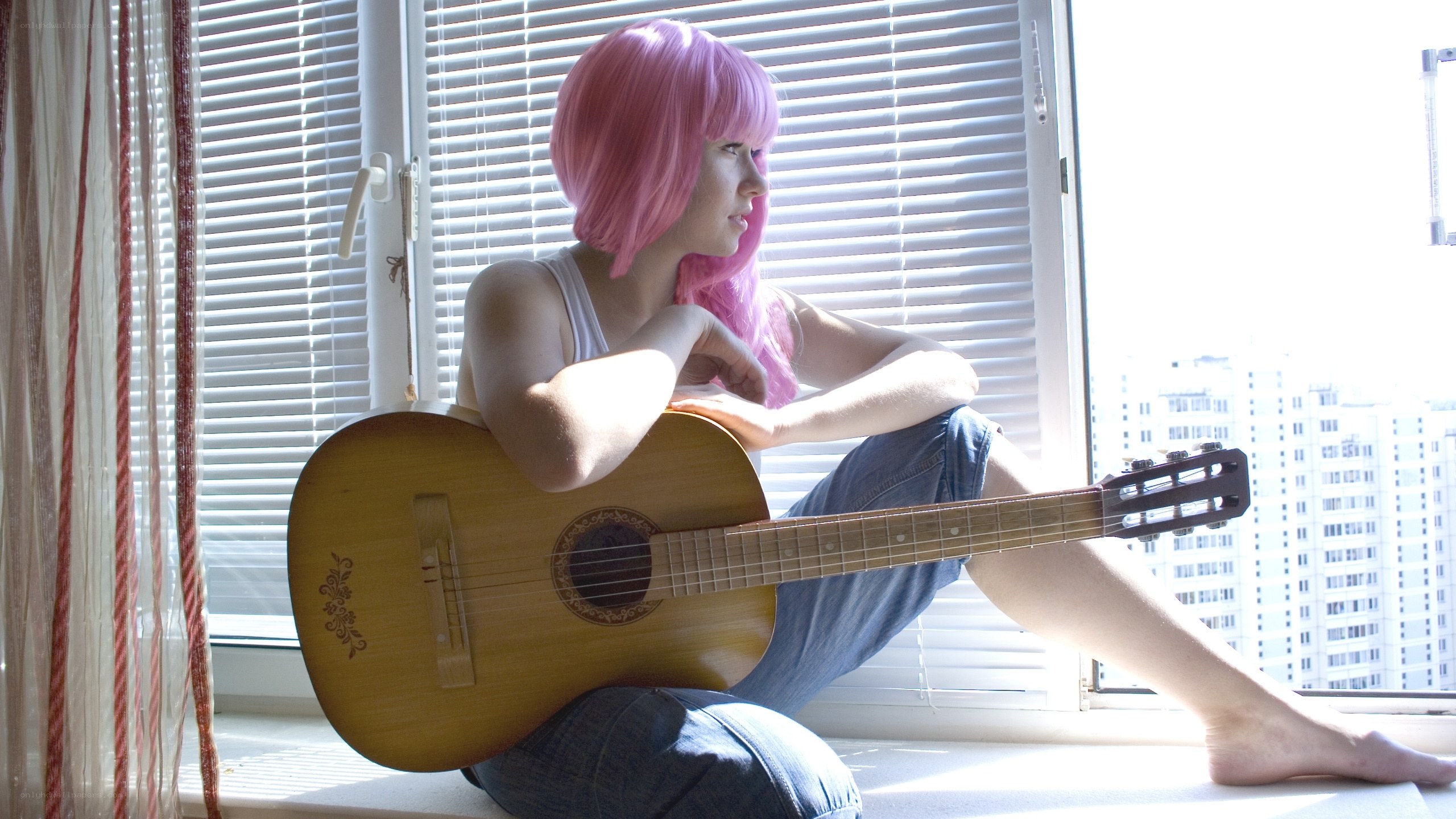 person with pink hair and guitar