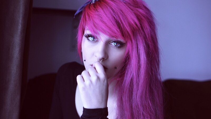 person with pink hair and piercings
