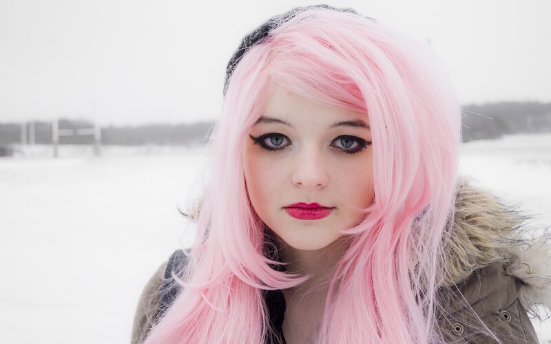 person with pink hair in snow