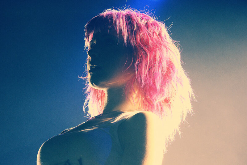 person with pink hair in spotlight