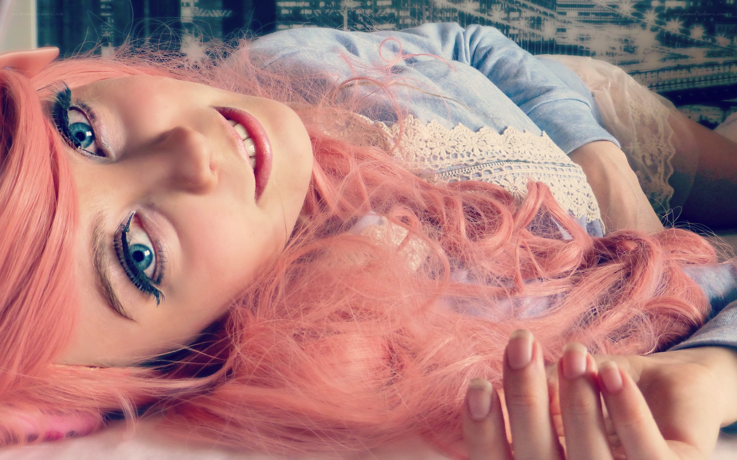 person with pink hair lying down