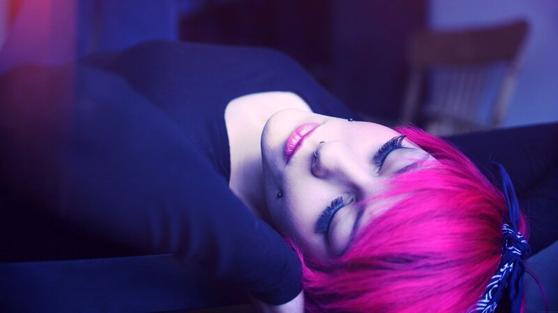 person with pink hair resting