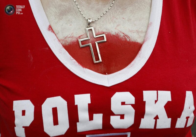 Person with 'Polska' shirt and cross