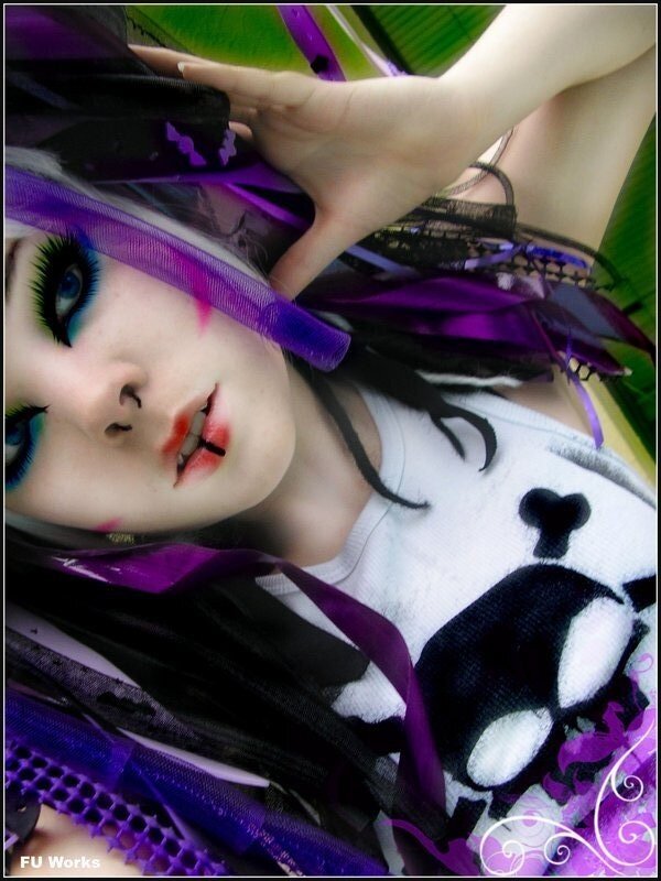 person with purple and black makeup