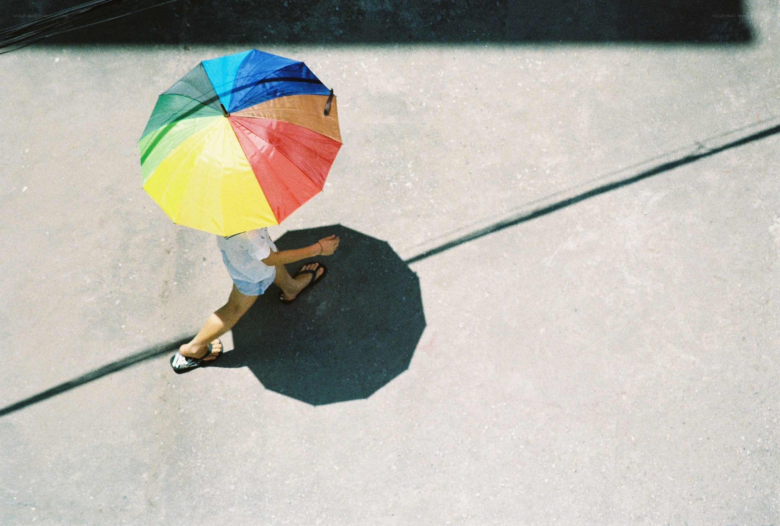 person with rainbow umbrella