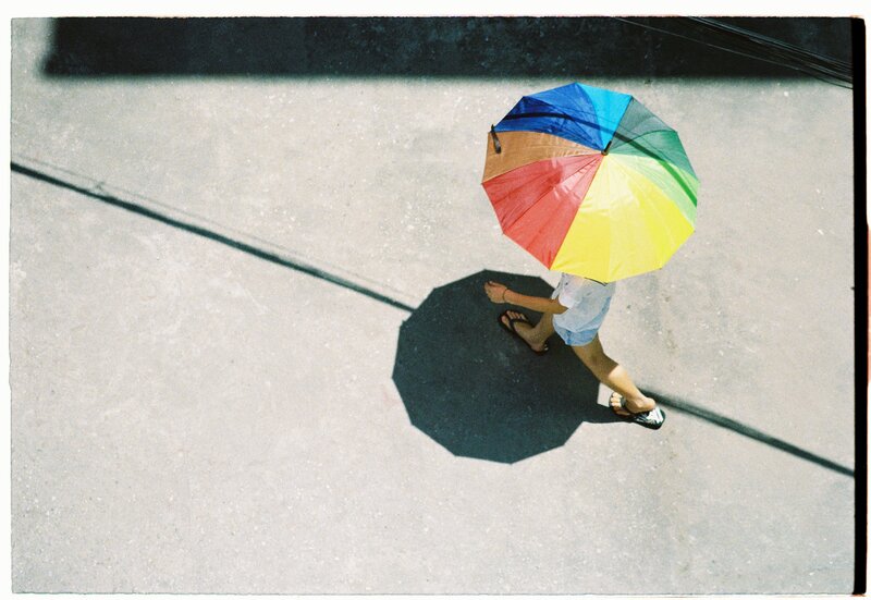 person with rainbow umbrella