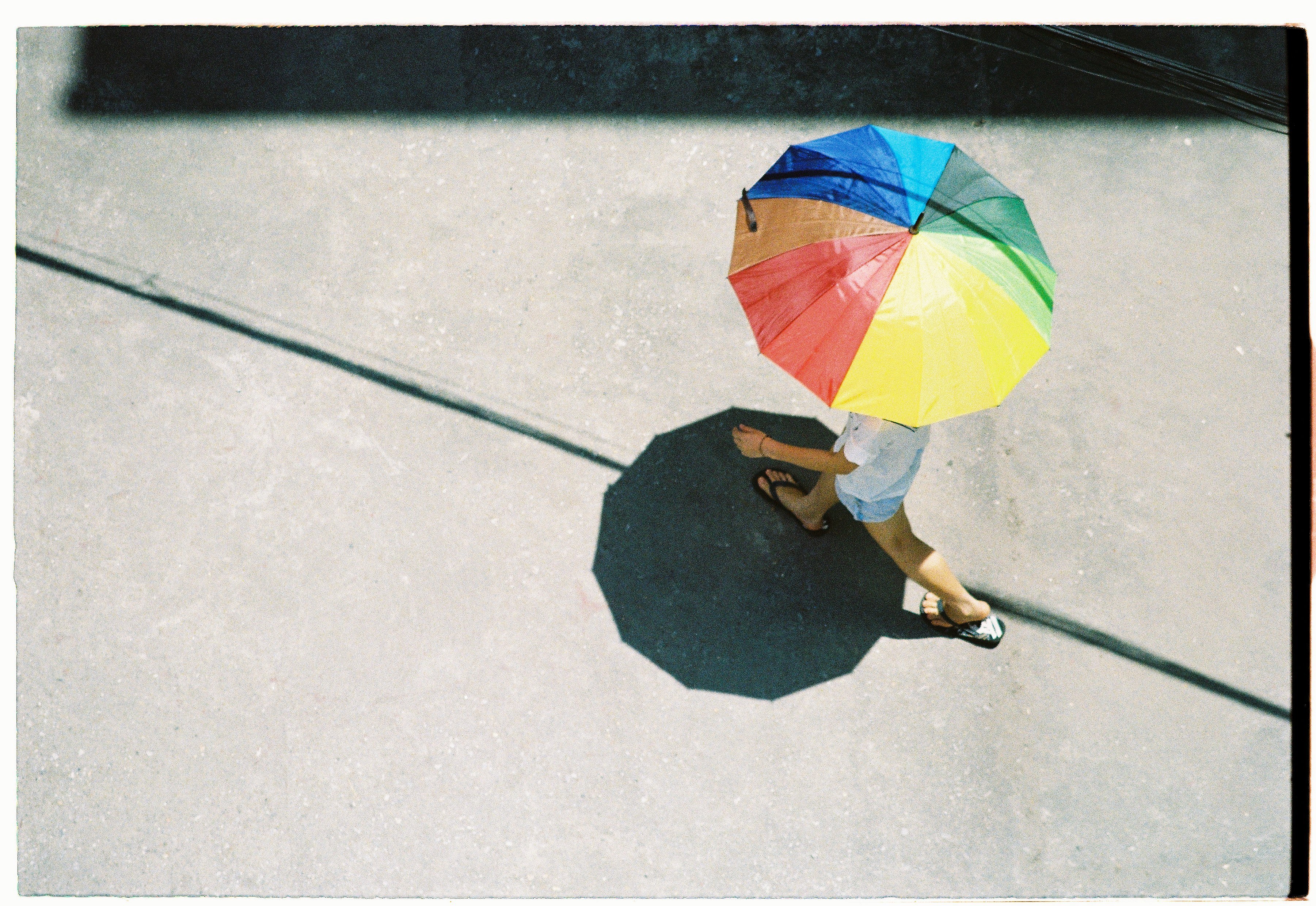 person with rainbow umbrella