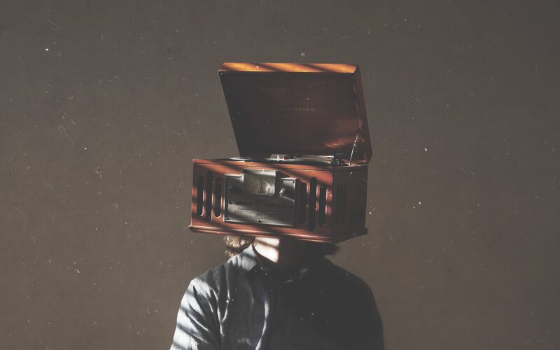 Person with Record Player on Head — Brown